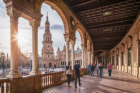 Tourists walking in the Plaza de Espana, Seville, Spain, Europe Tourists walking in the Plaza de Espana, Seville, Spain, Europe