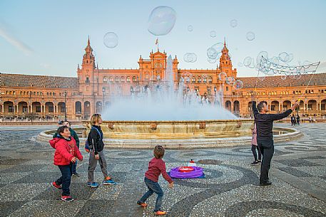 Street artist lets children play with bubbles in the Plaza de Espana, Seville, Andalusia, Spain, Europe