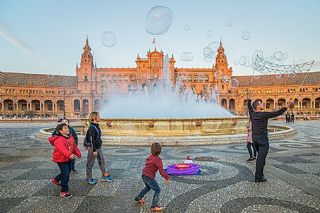 Street artist lets children play with bubbles in the Plaza de Espana, Seville, Andalusia, Spain, Europe Street artist lets children play with bubbles in the Plaza de Espana, Seville, Andalusia, Spain, Europe