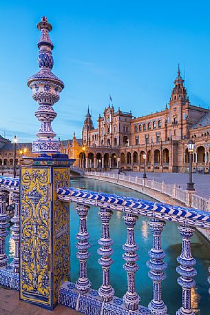 One of the four bridges with ceramic ornaments that crosses the Plaza de Espana canal at twilight, Seville, Andalusia, Spain, Europe