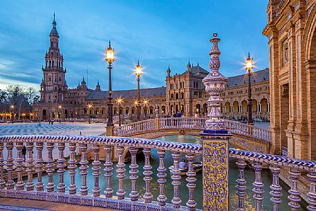 One of the four bridges with ceramic ornaments that crosses the Plaza de Espana canal at twilight, Seville, Andalusia, Spain, Europe