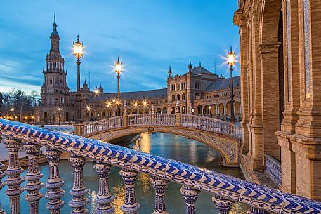 One of the four bridges with ceramic ornaments that crosses the Plaza de Espana canal at twilight, Seville, Andalusia, Spain, Europe