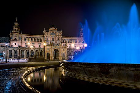 Fountain in the Plaza de Espana and in the background the government building by night, Seville, Andalusia, Spain, Europe