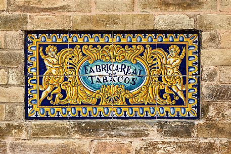 Sign of the Fabrica real De Tabacos, now part of the University of Seville, made of painted and glazed tiles, Seville, Andalusia, Spain, Europe Sign of the Fabrica real De Tabacos, now part of the University of Seville, made of painted and glazed tiles, Seville, Andalusia, Spain, Europe