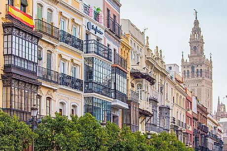 Palaces with typical wrought-iron terraces, on background appears the Giralda tower, Seville, Andalusia, Spain, Europe Palaces with typical wrought-iron terraces, on background appears the Giralda tower, Seville, Andalusia, Spain, Europe