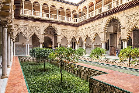 Patio de las Doncellas in the Real Alcazar palace, the lower part with plaster arches and stuccoes is in Mudejar style while the upper loggia shows the influence of the Italian Renaissance, Seville, Andalusia, Spain, Europe