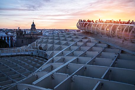 Tourist at twiilight looking the panorama from the roof of Metropol Parasol on plaza de la Encarnacion, commonly called Setas, a contemporary architecture project built entirely of wood, Seville, Andalusia, Spain, Europe