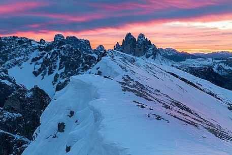The Tre Cime di Lavaredo during a flaming dawn, photographed from the Picco di Vallandro over Prato Piazza valley in the Fanes Senes Braies natural park, dolomites, Pustertal, South Tyrol, Italy, Europe