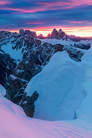 The Tre Cime di Lavaredo during a flaming dawn, photographed from the Picco di Vallandro over Prato Piazza valley in the Fanes Senes Braies natural park, dolomites, Pustertal, South Tyrol, Italy, Europe