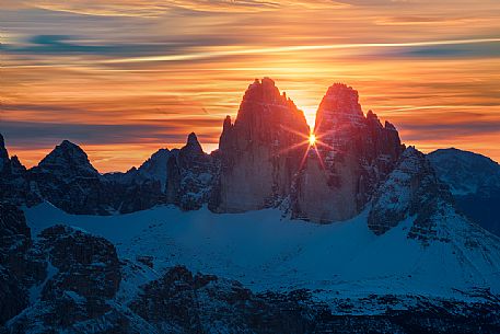 The sun rise between the Tre Cime di Lavaredo from the Picco di Vallandro over Prato Piazza valley in the Fanes Senes Braies natural park, dolomites, Pustertal, South Tyrol, Italy, Europe The sun rise between the Tre Cime di Lavaredo from the Picco di Vallandro over Prato Piazza valley in the Fanes Senes Braies natural park, dolomites, Pustertal, South Tyrol, Italy, Europe