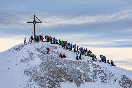 Hikers waiting for the sunrise from the Picco di Vallandro over Prato Piazza in the Fanes Senes Braies Natural Park, dolomites, Pustertal, South Tyrol, Italy, Europe