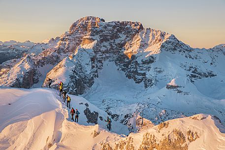 Hikers on the mountain ridge of the path that leading to the Vallandro Peak, on background the Croda Rossa over Prato Piazza Valley in the Fanes Senes Braies Natural Park, Pustertal, dolomites, South Tyrol, Italy, Europe Hikers on the mountain ridge of the path that leading to the Vallandro Peak, on background the Croda Rossa over Prato Piazza Valley in the Fanes Senes Braies Natural Park, Pustertal, dolomites, South Tyrol, Italy, Europe
