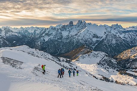 Hikers descend the mountain to Prato Piazza, on background Piz Popena and Cristallo Mount, Fanes Senes Braies Natural Park, Pustertal, dolomites, South Tyrol, Italy, Europe Hikers descend the mountain to Prato Piazza, on background Piz Popena and Cristallo Mount, Fanes Senes Braies Natural Park, Pustertal, dolomites, South Tyrol, Italy, Europe
