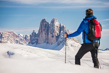 Hiker admires the Tre Cime di Lavaredo peak from Prato Piazza, Fanes Senes Braies Natural Park, Pustertal, dolomites, South Tyrol, Italy, Europe