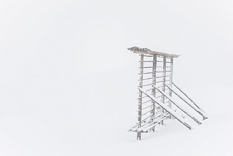An arfa, a typical alpine wooden rack, under an intensive snowfall, Sesto, Alta Pusteria, dolomites, Trentino Alto Adige, Italy, Europe An arfa, a typical alpine wooden rack, under an intensive snowfall, Sesto, Alta Pusteria, dolomites, Trentino Alto Adige, Italy, Europe