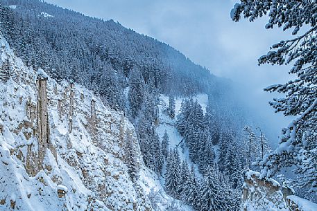 The Piramidi di terra or Earth Pyramids of the small village of Plata after an intensive snowfall, Perca, Pusteria valley, dolomites, Trentino Alto Adige, Italy, Europe