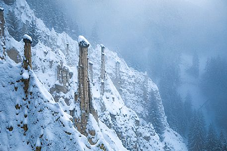 The Piramidi di terra or Earth Pyramids of the small village of Plata after an intensive snowfall, Perca, Pusteria valley, dolomites, Trentino Alto Adige, Italy, Europe