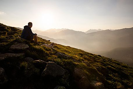 Trekker with dog admires the panoramic view over the Rolle Pass, San Martino di Castrozza, dolomites, Trentino Alto Adige, Italy, Europe Trekker with dog admires the panoramic view over the Rolle Pass, San Martino di Castrozza, dolomites, Trentino Alto Adige, Italy, Europe