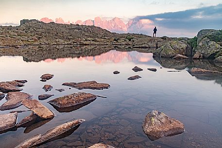 Hiker at the Juribrutto lakes with Pale di San Martino mountain group at sunset, San Martino di Castrozza, dolomites, Trentino Alto Adige, Italy, Europe Hiker at the Juribrutto lakes with Pale di San Martino mountain group at sunset, San Martino di Castrozza, dolomites, Trentino Alto Adige, Italy, Europe