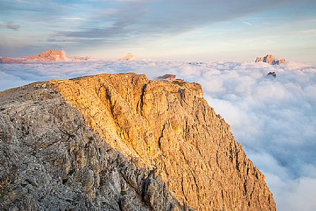 Panoramic view towards Lagazuoi refuge with Pelmo and Sorapiss peaks coming up from clouds, Cortina d'Ampezzo, dolomites, Veneto, Italy, Europe
