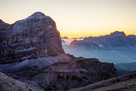 The sun rises behind Tofana di Rozes Mount, Cortina d'Ampezzo, dolomites, Veneto, Italy, Europe