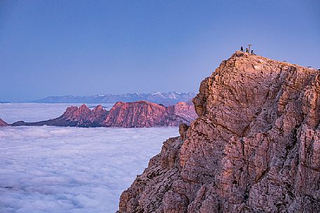 Tourists on the top of Lagazuoi mount, the clouds wrap the mountains, Cortina d'Ampezzo, Veneto, Italy, Europe Tourists on the top of Lagazuoi mount, the clouds wrap the mountains, Cortina d'Ampezzo, Veneto, Italy, Europe