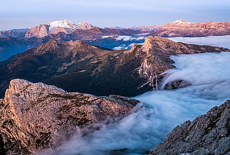 Clouds wrap around the landscape nearby Lagazuoi refuge, in the background the Marmolada mount, Cortina d'Ampezzo, Veneto, Italy, Europe