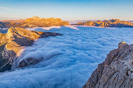 Hiker looks the sunrise and the clouds wrap around the landscape nearby Lagazuoi Refuge, Cortina d'Ampezzo, Veneto, Italy, Europe Hiker looks the sunrise and the clouds wrap around the landscape nearby Lagazuoi Refuge, Cortina d'Ampezzo, Veneto, Italy, Europe