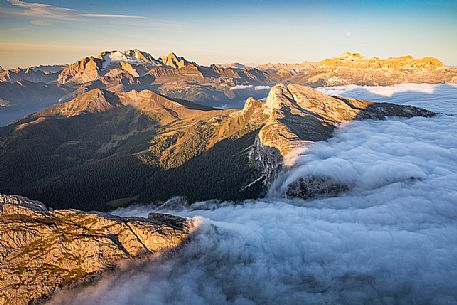 Clouds wrap around the landscape nearby Lagazuoi refuge, in the background the Marmolada mount, Cortina d'Ampezzo, Veneto, Italy, Europe