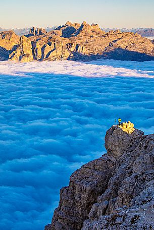 Photographer looks the sunrise towards the Odle Puez natural park and the clouds wrap around the landscape nearby Lagazuoi Refuge, Cortina d'Ampezzo, Veneto, Italy, Europe Photographer looks the sunrise towards the Odle Puez natural park and the clouds wrap around the landscape nearby Lagazuoi Refuge, Cortina d'Ampezzo, Veneto, Italy, Europe