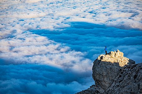 Photographer sourranded by a low clouds sea on the top of Lagazuoi mount, Cortina d'Ampezzo, dolomites, Veneto, Italy, Europe Photographer sourranded by a low clouds sea on the top of Lagazuoi mount, Cortina d'Ampezzo, dolomites, Veneto, Italy, Europe