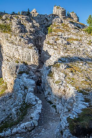 Trekker on the trenches of the World War in the Cinque Torri area, Cortina d'Ampezzo, dolomites, Veneto, Italy, Europe Trekker on the trenches of the World War in the Cinque Torri area, Cortina d'Ampezzo, dolomites, Veneto, Italy, Europe