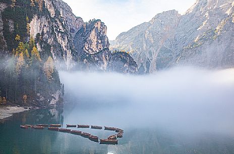 Moored boats in the lake of Braies in autumn, dolomites, Pusteria valley, Trentino Alto Adige, South Tyrol, Italy, Europe
