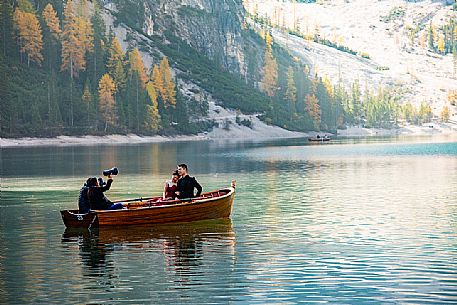Photo shooting for a pair on Lake Braies with autumn colors, dolomites, Pusteria valley, Trentino Alto Adige, South Tyrol, Italy, Europe