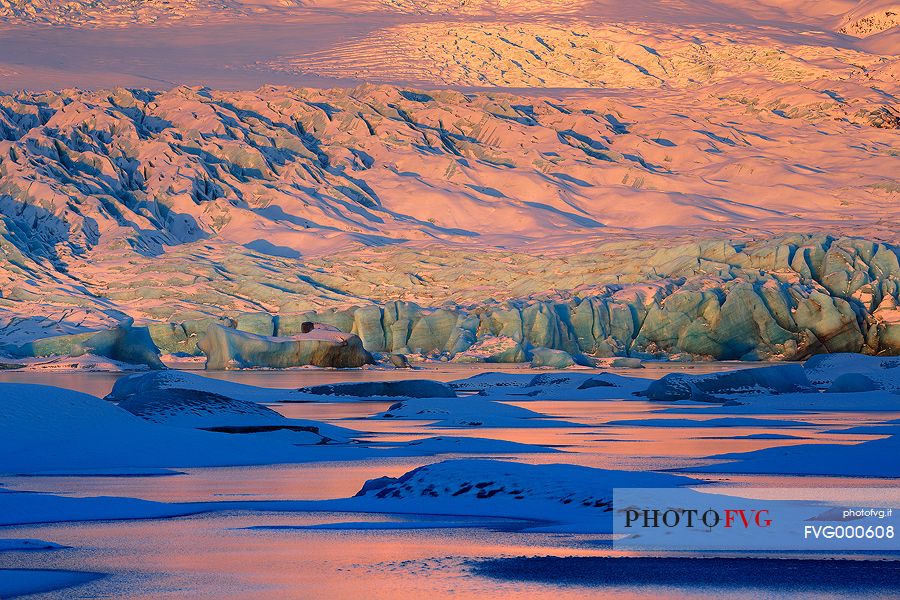 A detail of colourful Vatnajkull ice at the first light of sunrise.