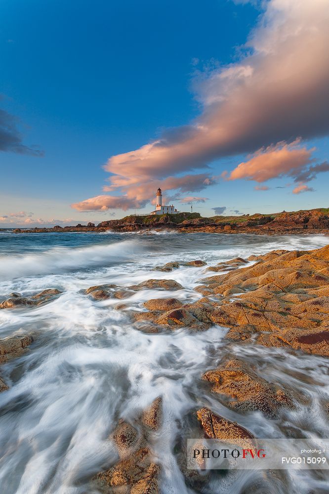 This picture of the lighthouse has been taken during the sunset, standing on the rocks