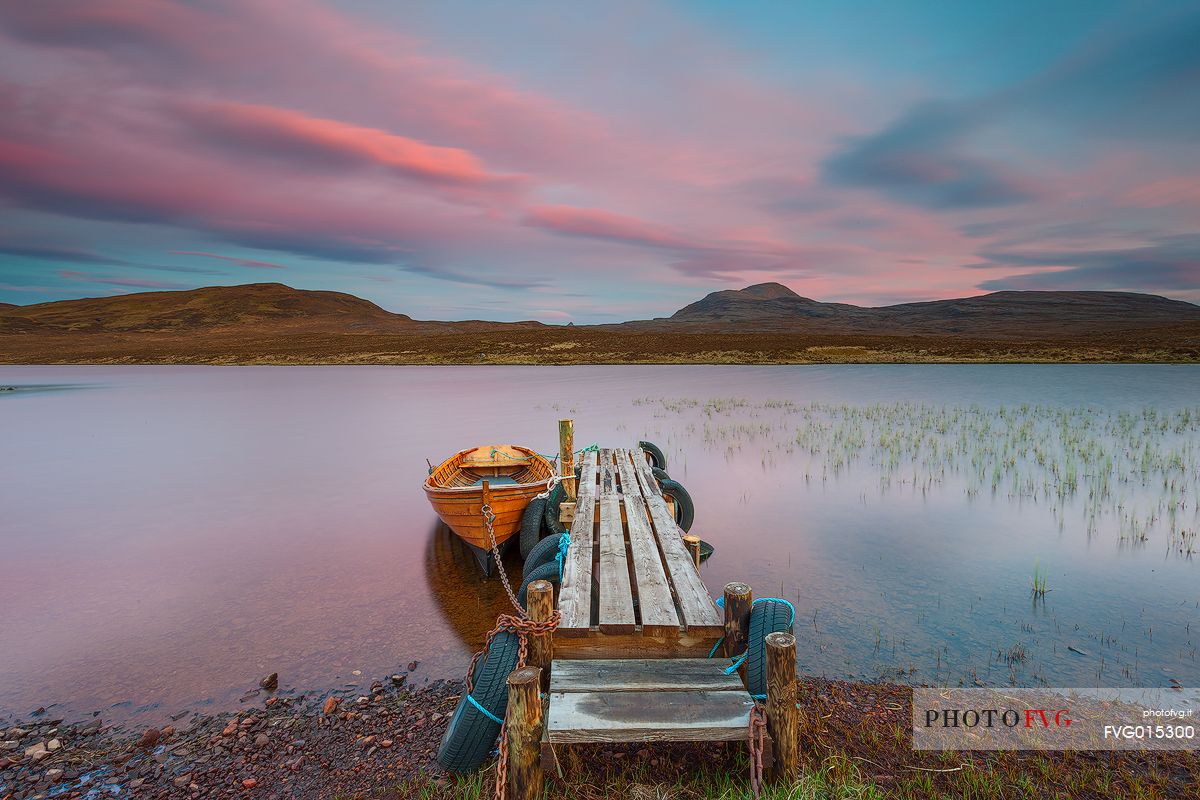 The fishermans boats anchored on the shore of the fascinating Loch Assynt