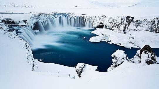 The winter climate embraces the celestial waters of Godafoss.