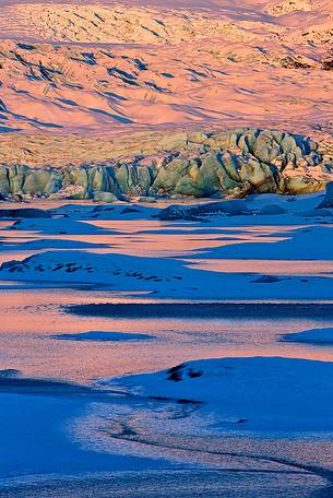A detail of colourful Vatnajkull ice at the first light of sunrise.