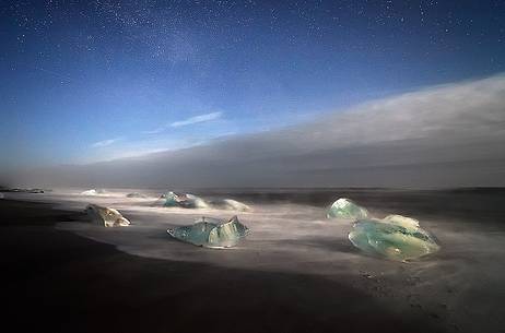A fascinating starry night frames the ice at Jokulsarlon.