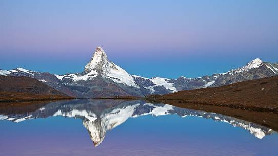 The Summit of the Matterhorn reflected in Stellisee during a relaxing sunrise The Summit of the Matterhorn reflected in Stellisee during a relaxing sunrise