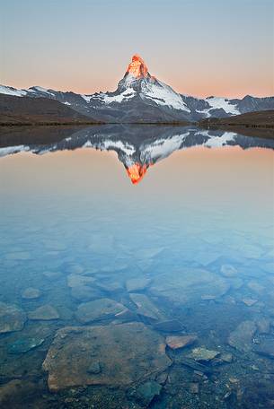 The Summit of the Matterhorn reflected in Stellisee during a relaxing sunrise The Summit of the Matterhorn reflected in Stellisee during a relaxing sunrise