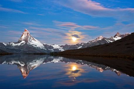The fusion of sunrise and moonset light generated a fascinating mood at stellisee Lake The fusion of sunrise and moonset light generated a fascinating mood at stellisee Lake