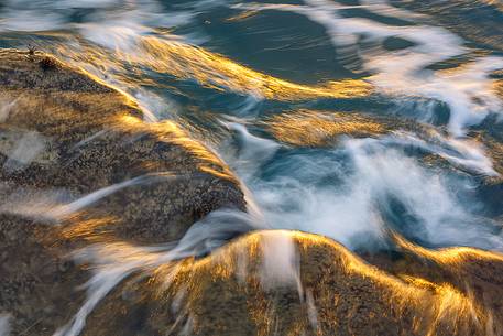 A texture shaped by light and waves during the sunrise