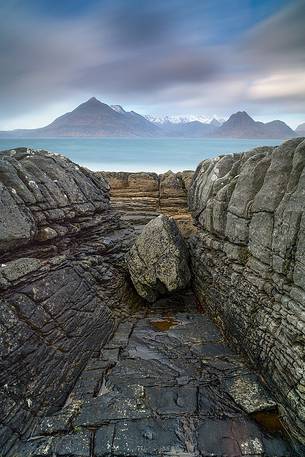 The Cuillin Hills view from Elgol Beach is simply amazing. Thanks to the long time exposure this picture shows the contrast between the static rocks and the dynamic sky on the background