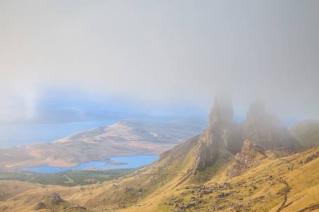 The clouds embraced the famous pinnacle of Old Man of Storr during a misty morning