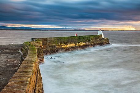The wind and waves at Burghead Harbor during the sunset