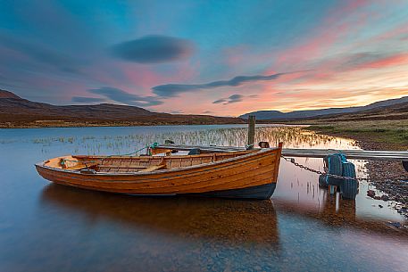 The fishermans boats anchored on the shore of the fascinating Loch Assynt