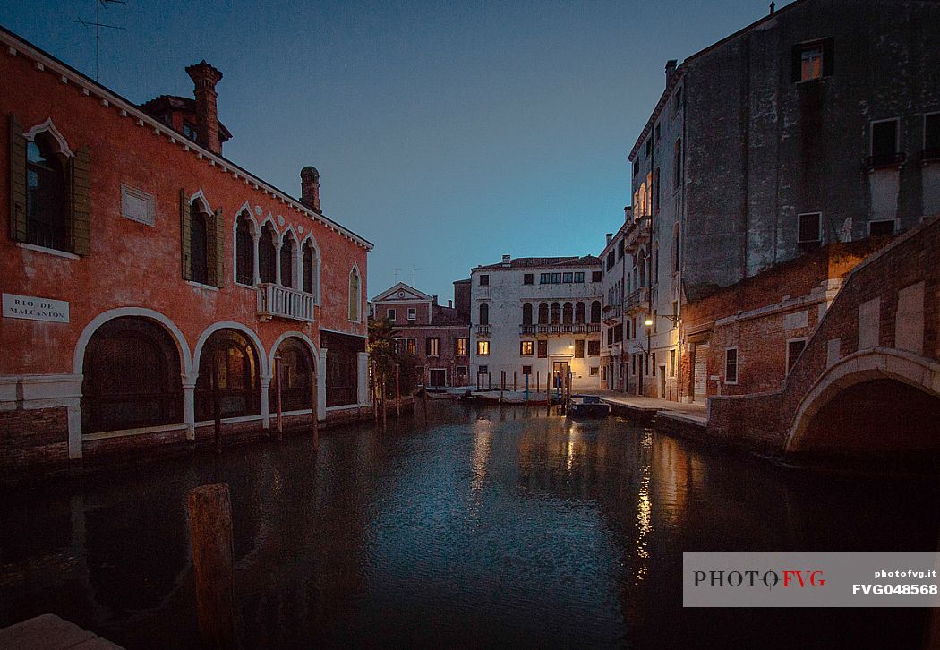 Dusk view on a typical venetian canal with Venice, Veneto, Italy, Europe
