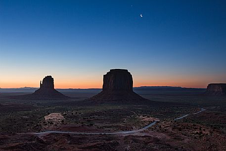 Scenic view of the first light of the dawn on the background of The Mittens and Merrick Butte  from John Wayne's Point the Oljato Navajo Monument Valley, Arizona USA 